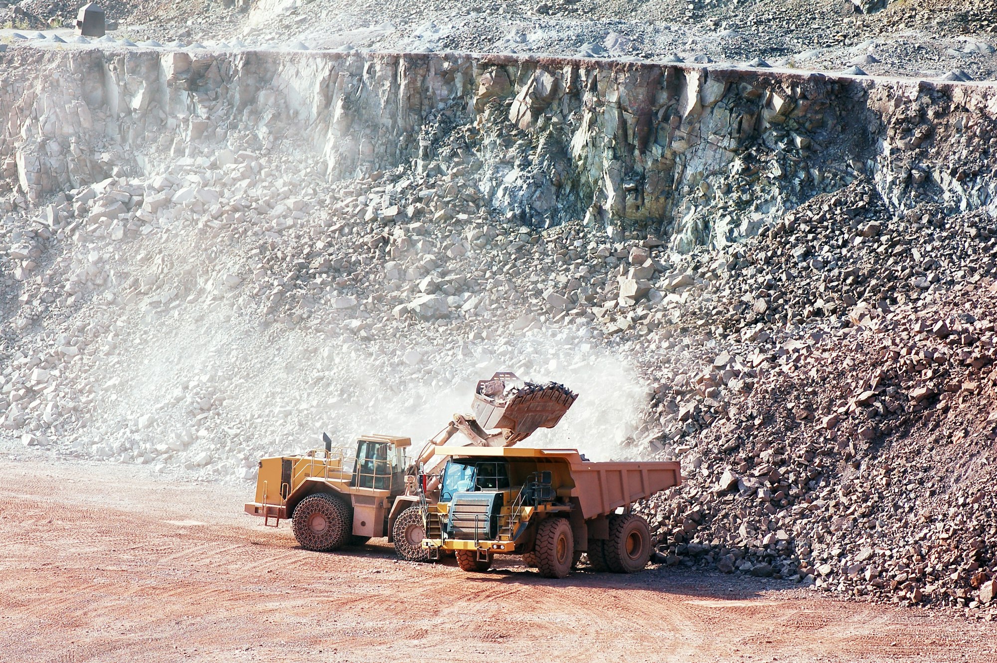 Home 14 earth mover loading stones on a dumper truck. mining industries.